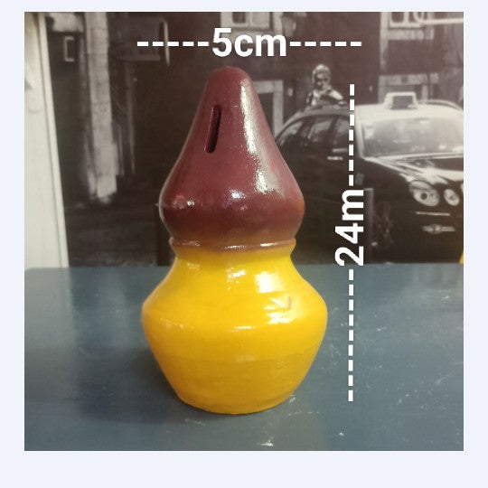 Yellow and red ceramic object with measurements on a blurred background